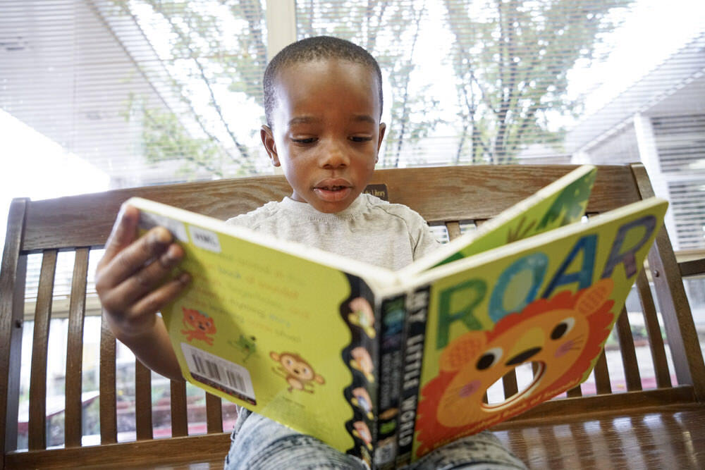 Boy reading ROAR book 6 DSC02350