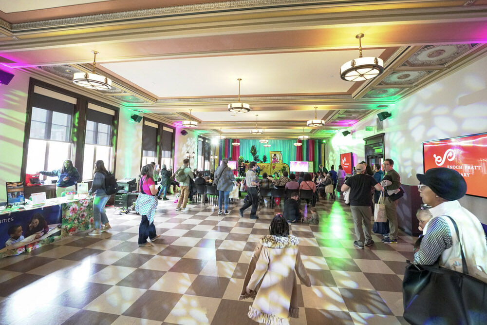 special event in the Creative Arts room with people, colorful lights, and signs