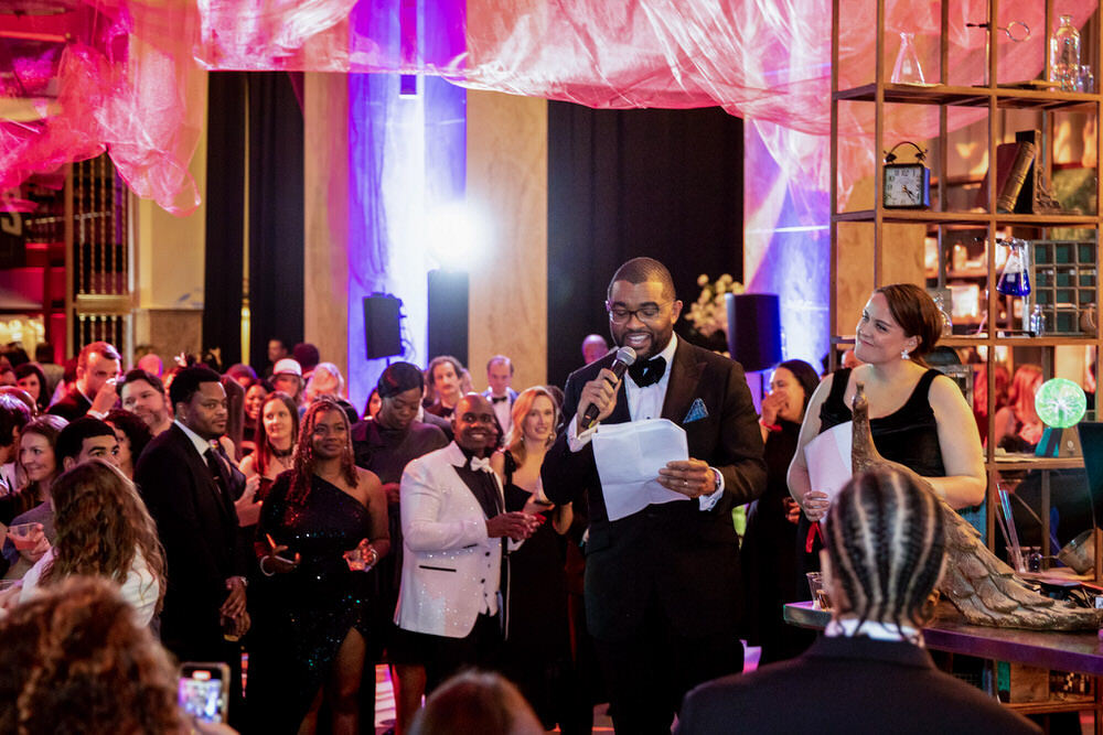 fundraiser event - Black and White at Pratt with an MC and crowd of people