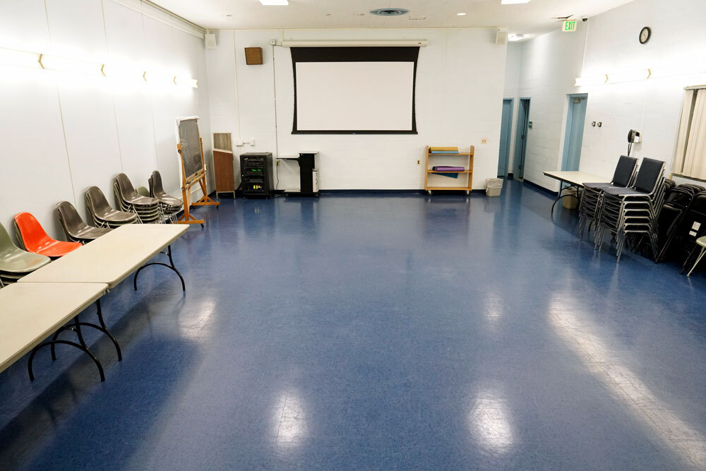 Brooklyn meeting room showing projection screen, tables and chairs along the side