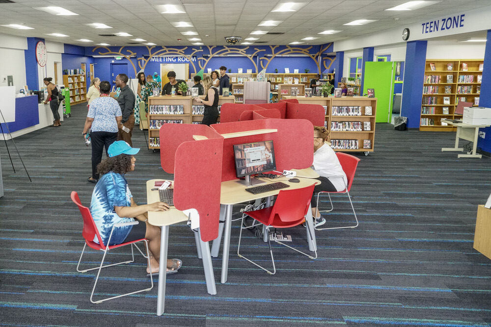 inside view of the Walbrook library with people, computers, and books
